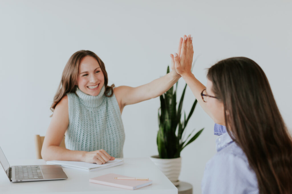 celebratory-brand-photo-female-business-owner-hi-five-the-frame-Charlotte