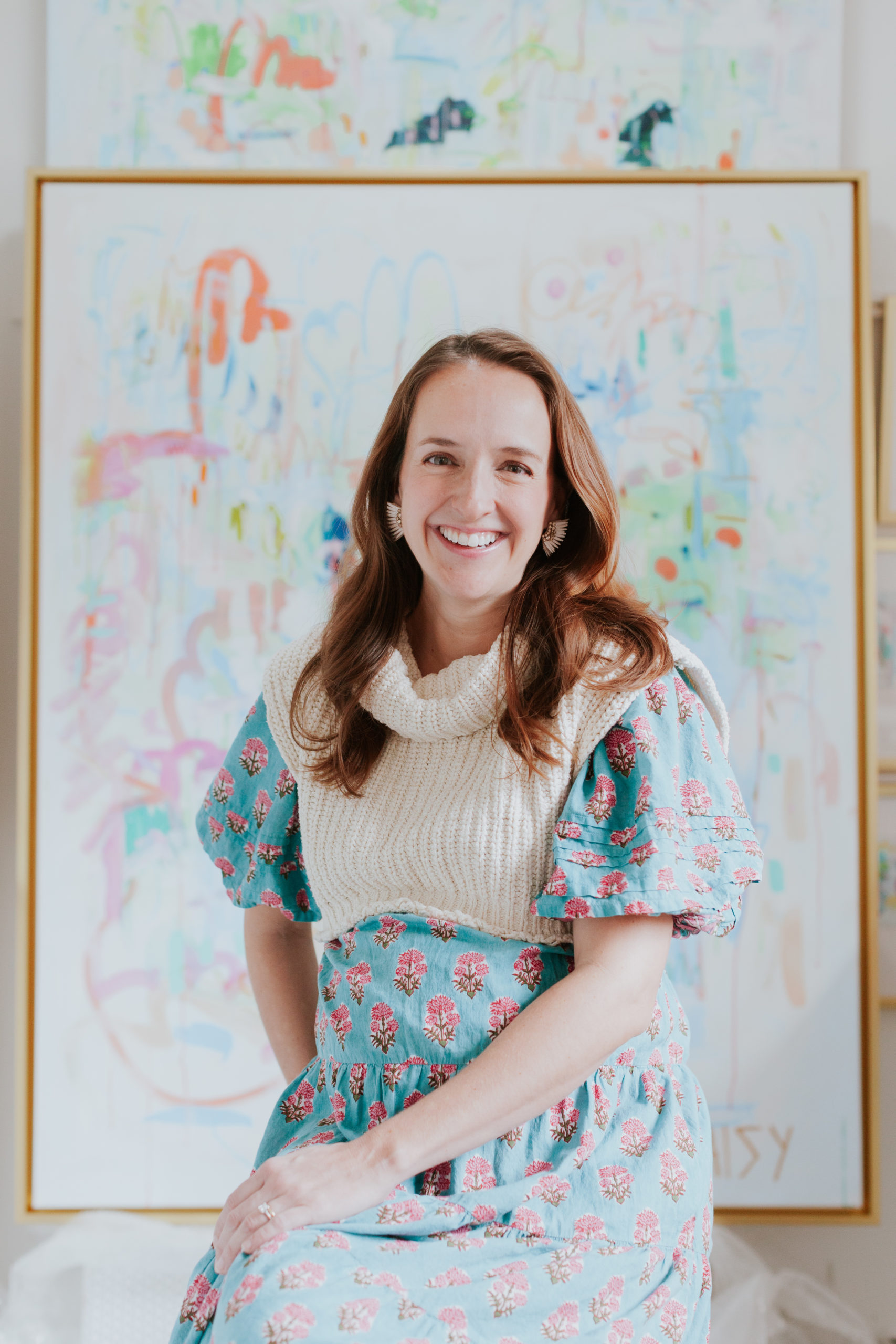 Headshot of Megan Daisy Milner in her studio with her art