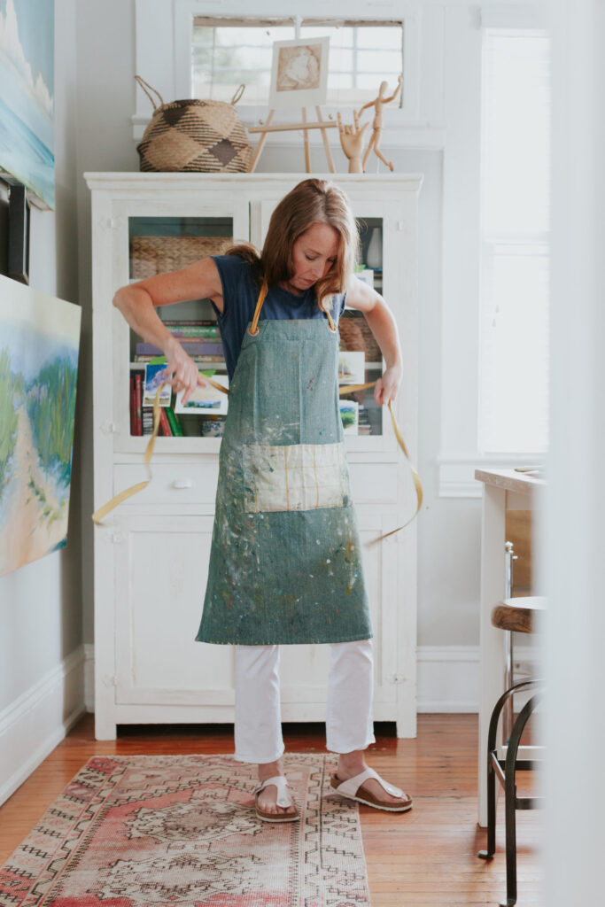 studioworks-artist-brand-photo-tying-apron-in-studio-dilworth-east-blvd-Charlotte