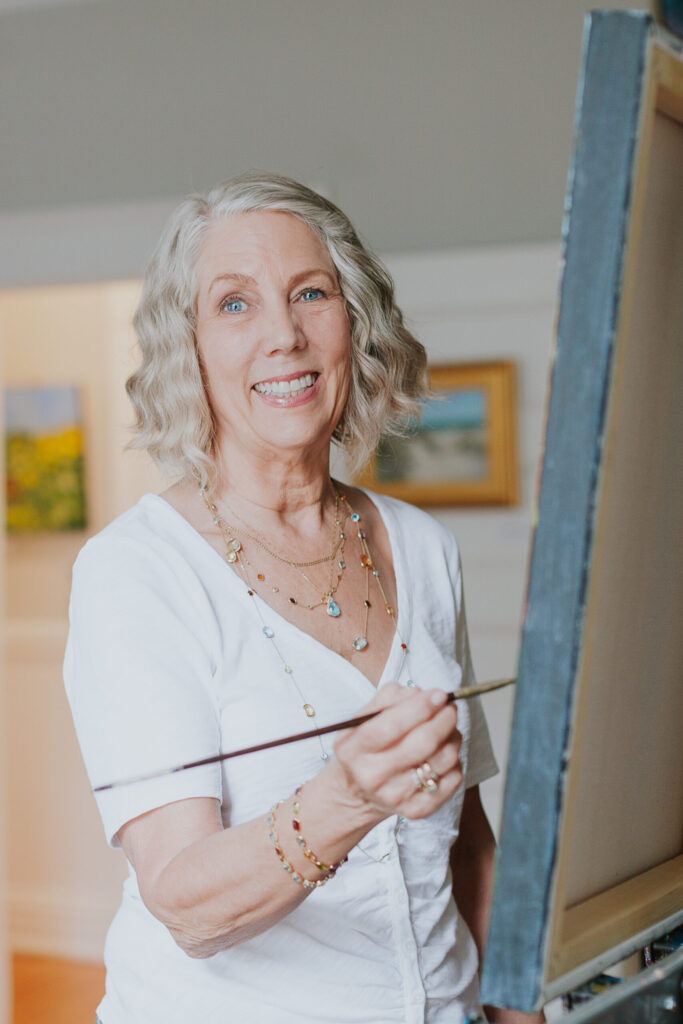 artist-headshot-smiling-at-easel-studioworks-charlotte-dilworth