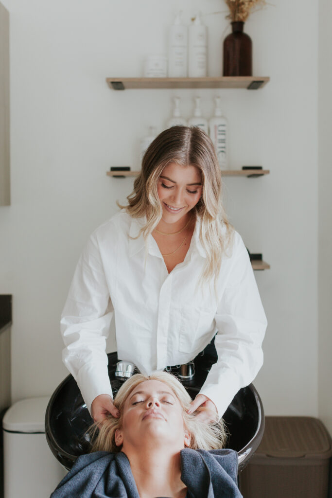 process-photo-female-hair-stylist-washing-client-hair-south-charlotte-salon