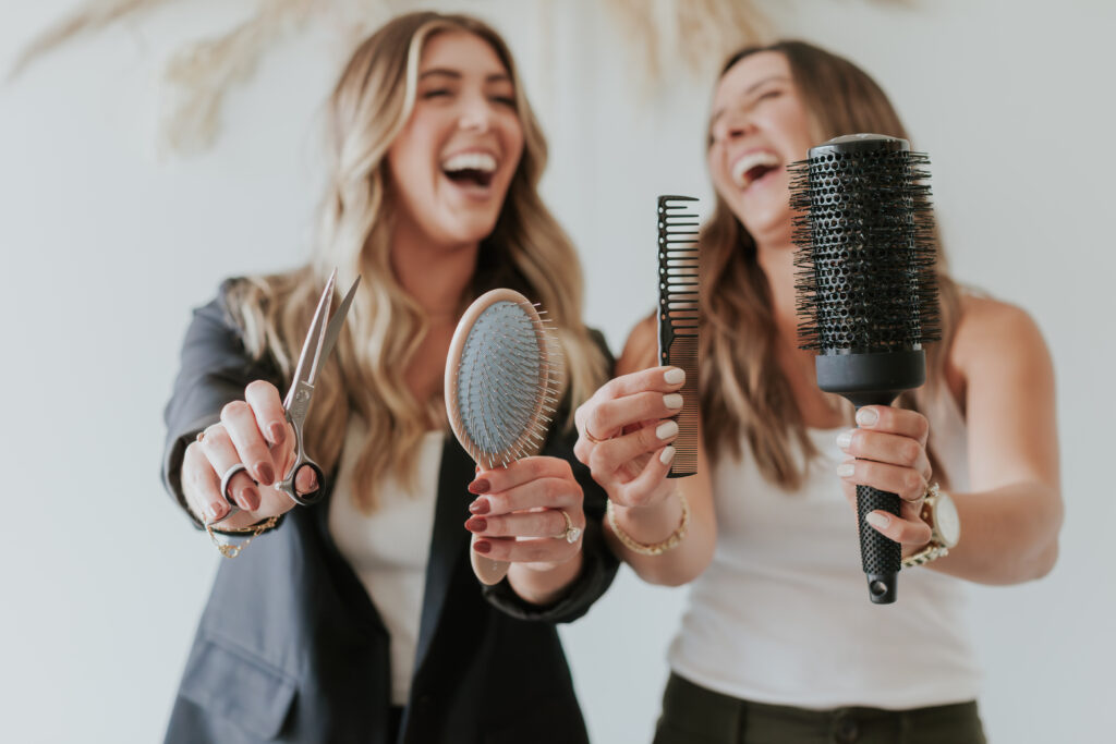 playful-photo-for-brand-session-female-hairstylists-holding-tools-south-Charlotte