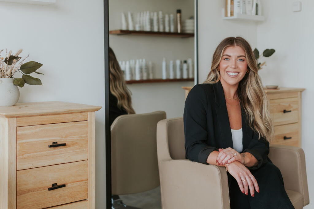 female-hairstylist-seated-headshot-for-south-charlotte-salon-brand-session