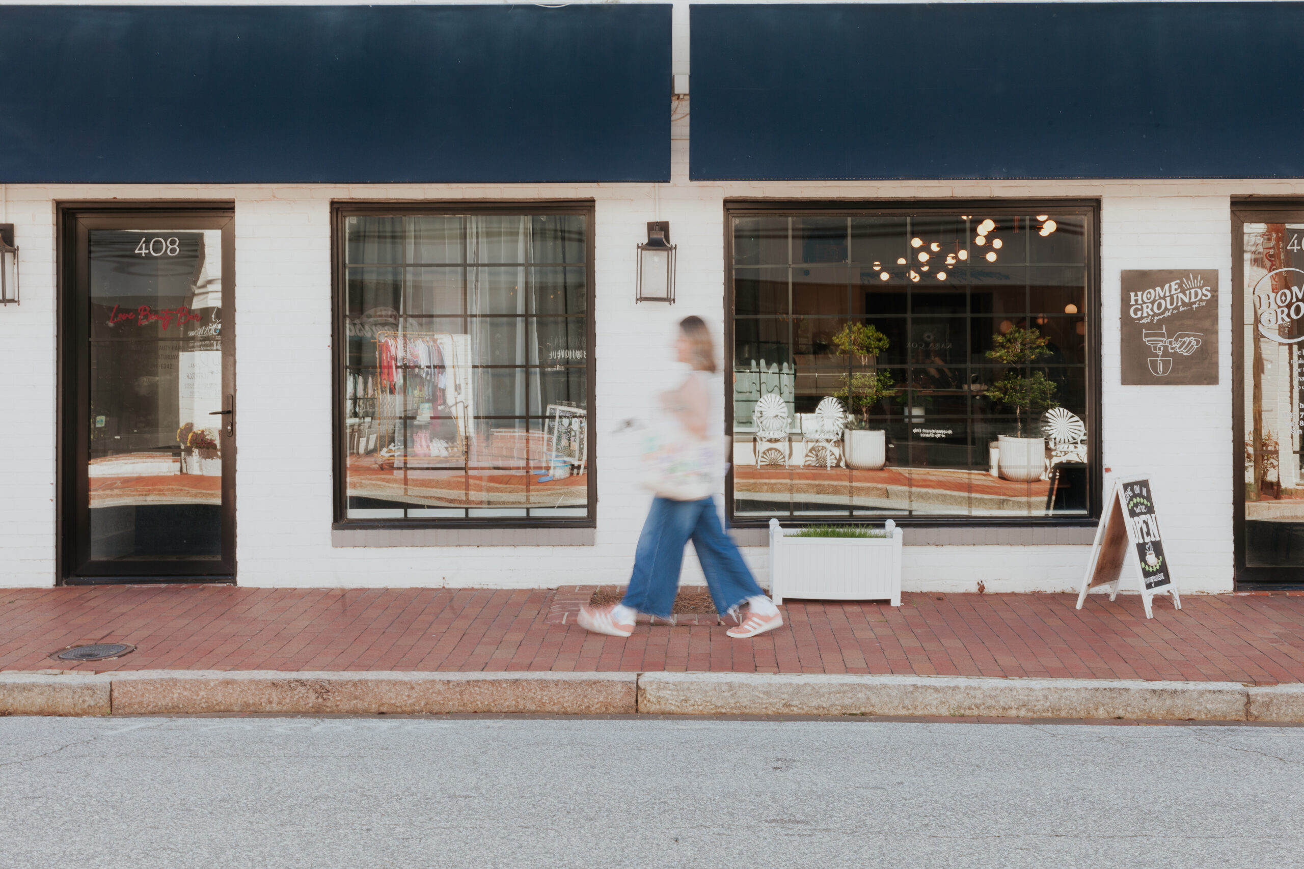 woman walking on sidewalk in small town